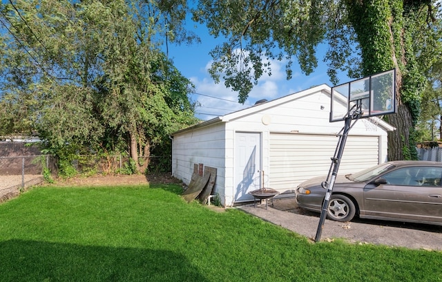 exterior space featuring a garage, an outdoor structure, and a yard