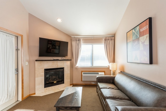 carpeted living room with an AC wall unit, vaulted ceiling, and a fireplace