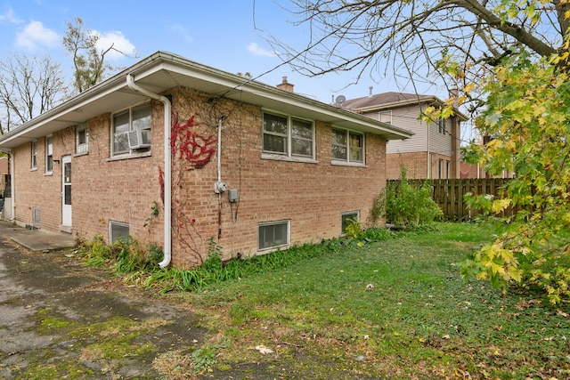 view of side of property with a yard