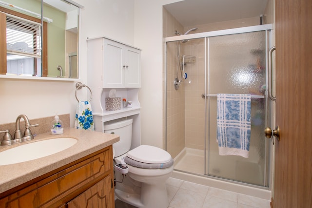 bathroom featuring walk in shower, toilet, vanity, and tile patterned floors