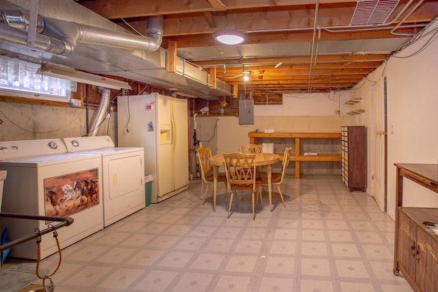 basement featuring electric panel, white fridge with ice dispenser, and washer and clothes dryer