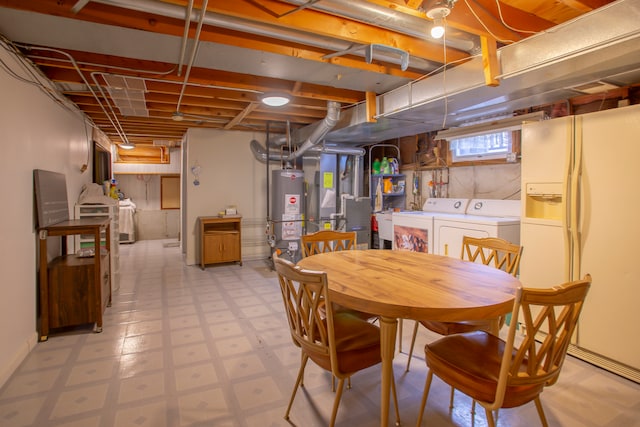 basement featuring heating unit, white fridge with ice dispenser, gas water heater, and washer and dryer