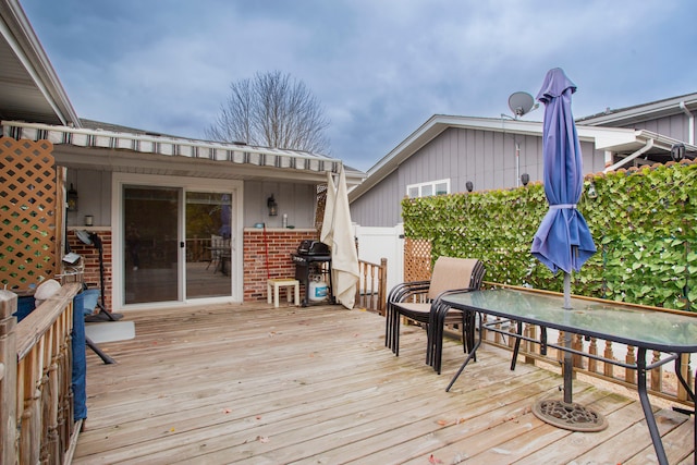 wooden terrace featuring a grill