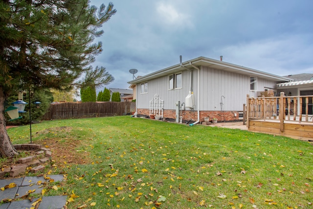 view of side of property featuring a wooden deck and a yard