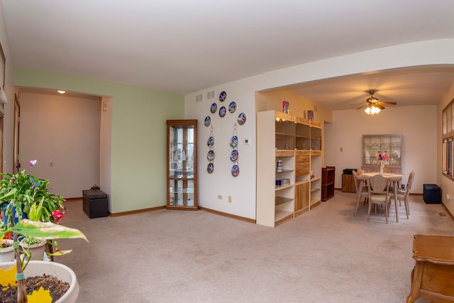 living room with carpet flooring and ceiling fan