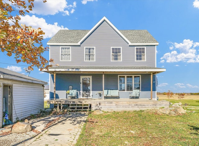 view of front of property with a front yard and covered porch