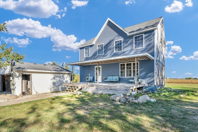 back of property with a lawn and a deck