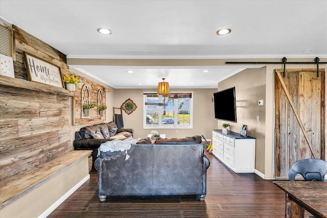 living room featuring a barn door, dark wood-type flooring, and crown molding