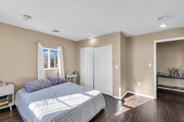 bedroom featuring dark hardwood / wood-style floors and a closet