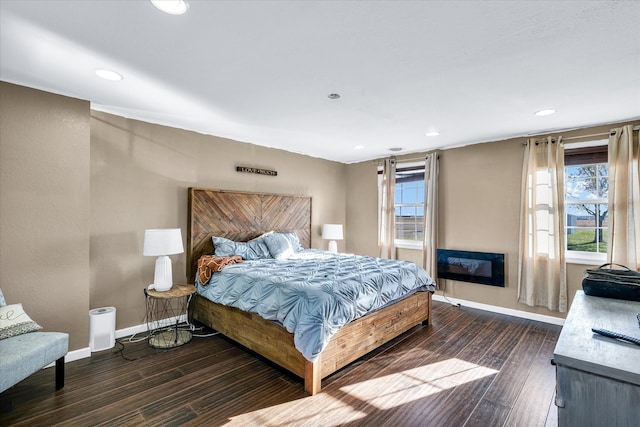 bedroom with dark hardwood / wood-style flooring