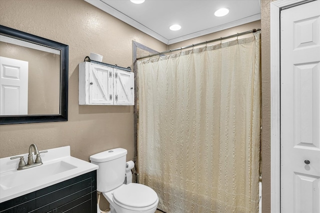 bathroom with curtained shower, vanity, and toilet