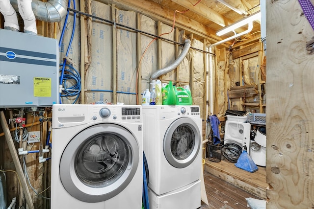 clothes washing area with hardwood / wood-style floors and washing machine and clothes dryer