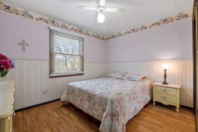 bedroom featuring hardwood / wood-style floors and ceiling fan