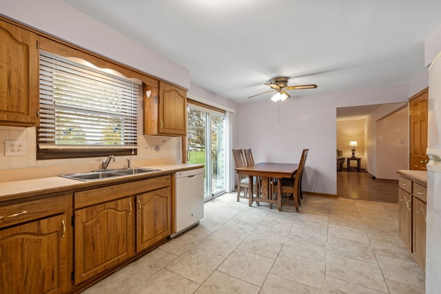 kitchen with tasteful backsplash, ceiling fan, sink, dishwasher, and light tile patterned flooring