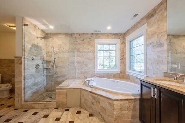 full bathroom with toilet, vanity, independent shower and bath, and tile walls