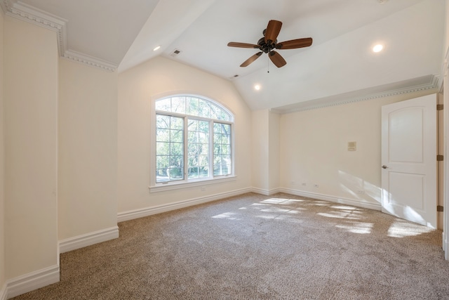 carpeted spare room featuring ceiling fan and vaulted ceiling