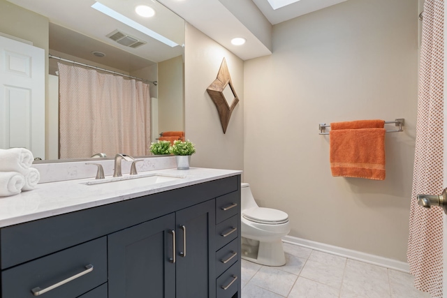 bathroom with toilet, tile patterned floors, and vanity