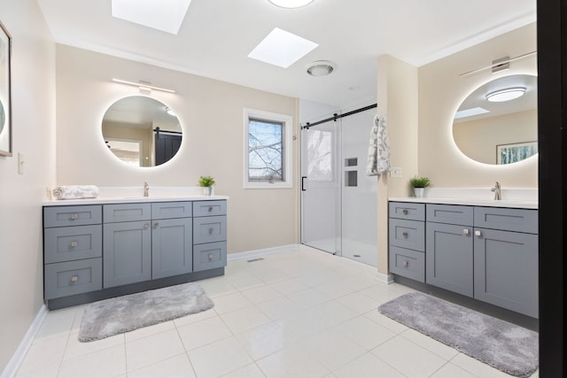 bathroom featuring vanity, tile patterned floors, a skylight, and a shower with shower door