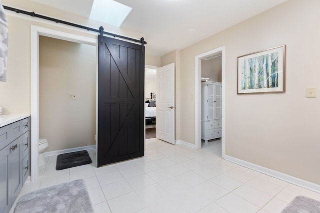 bathroom featuring toilet, tile patterned floors, and vanity