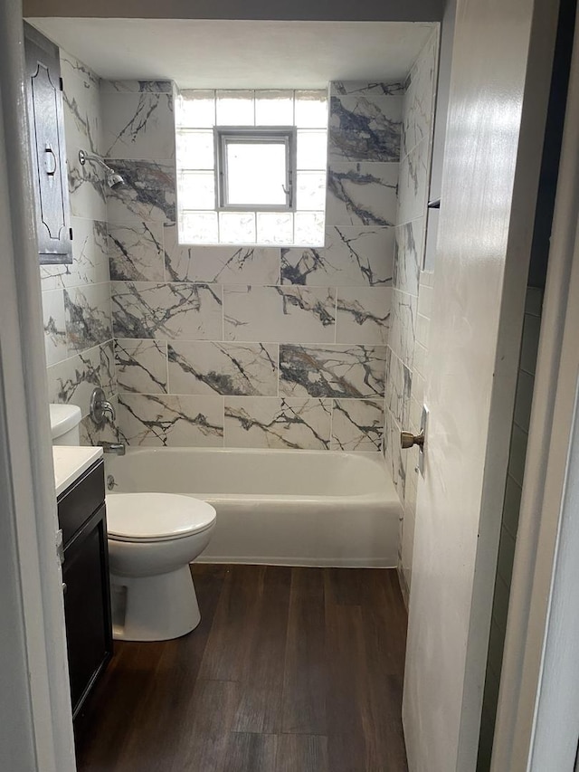 full bathroom with toilet, vanity, tiled shower / bath combo, and hardwood / wood-style flooring