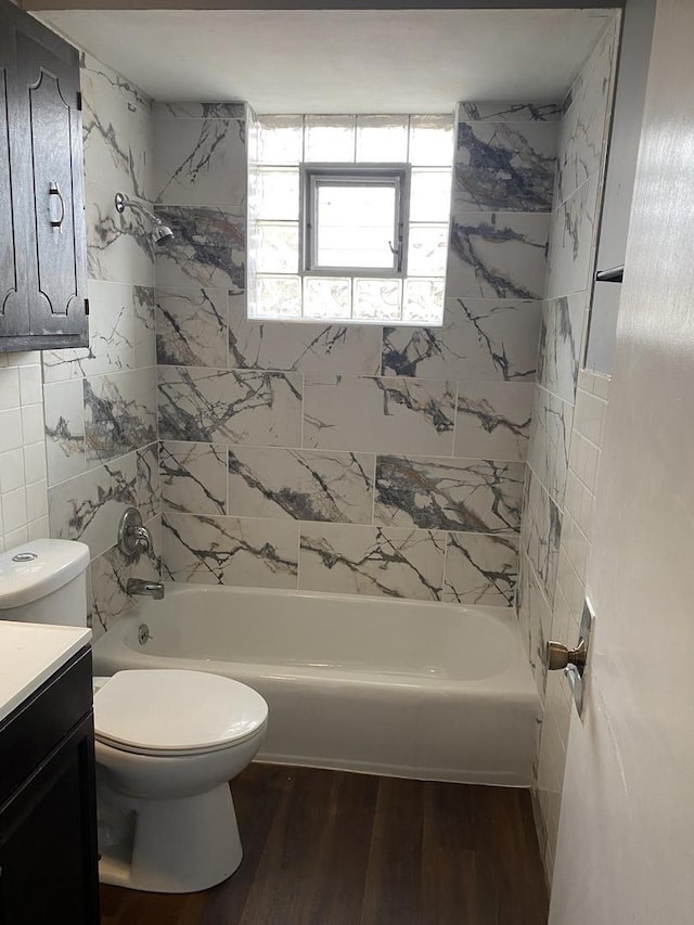 full bathroom with vanity, toilet, tiled shower / bath, and hardwood / wood-style flooring