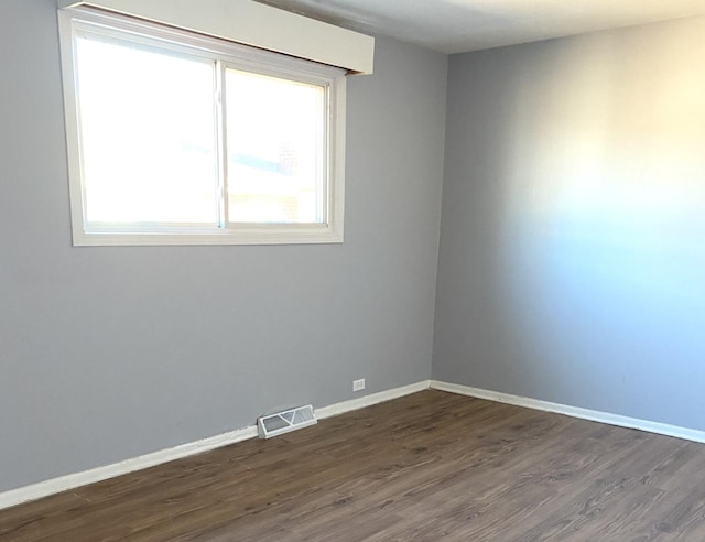 empty room featuring dark wood-type flooring