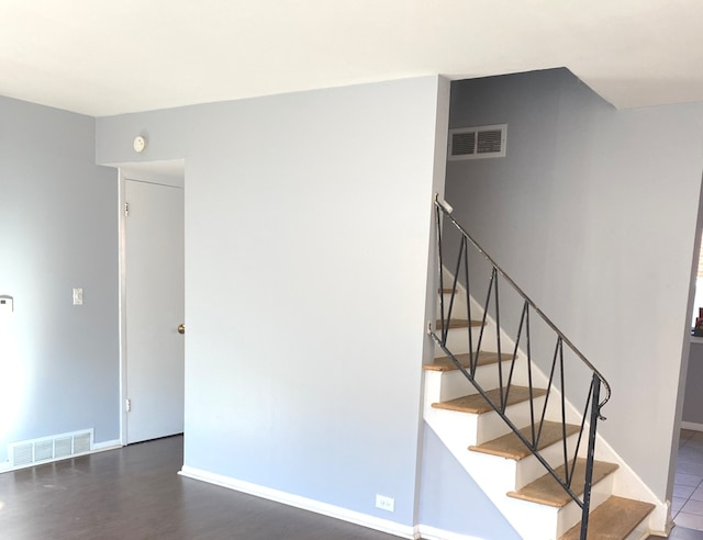 staircase with hardwood / wood-style flooring