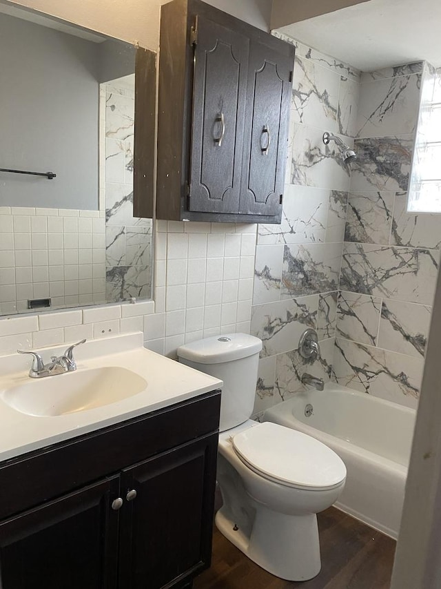 full bathroom featuring vanity, hardwood / wood-style flooring, decorative backsplash, toilet, and tub / shower combination