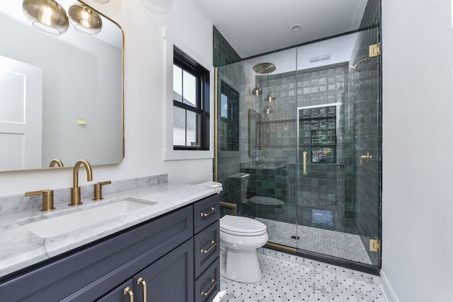 bathroom with a shower with door, vanity, and toilet