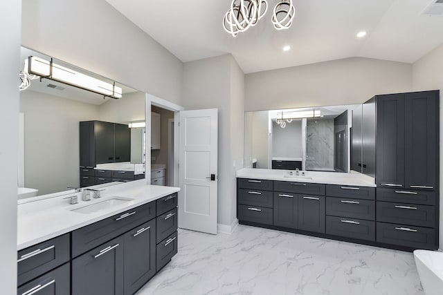 bathroom featuring vanity, an inviting chandelier, and lofted ceiling