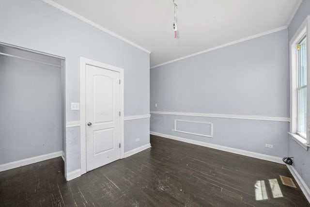 unfurnished bedroom with ornamental molding, multiple windows, and dark hardwood / wood-style floors