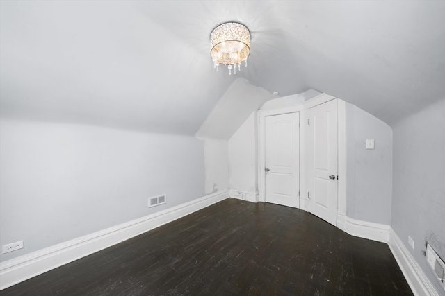 additional living space featuring hardwood / wood-style flooring and lofted ceiling