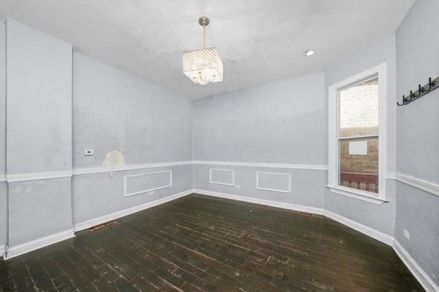 unfurnished room featuring dark hardwood / wood-style flooring