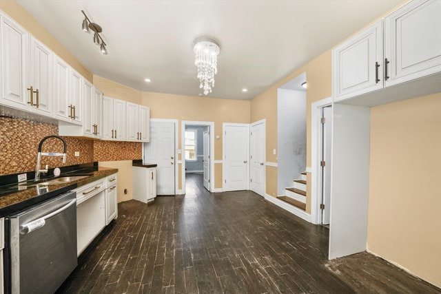 kitchen with stainless steel dishwasher, white cabinets, sink, and dark hardwood / wood-style flooring