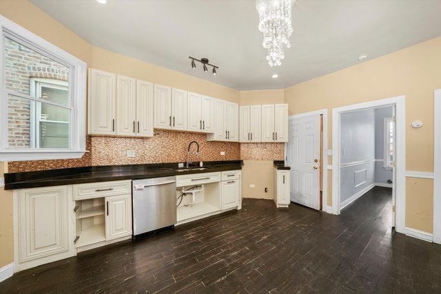 kitchen featuring dishwasher, dark hardwood / wood-style floors, sink, and white cabinets