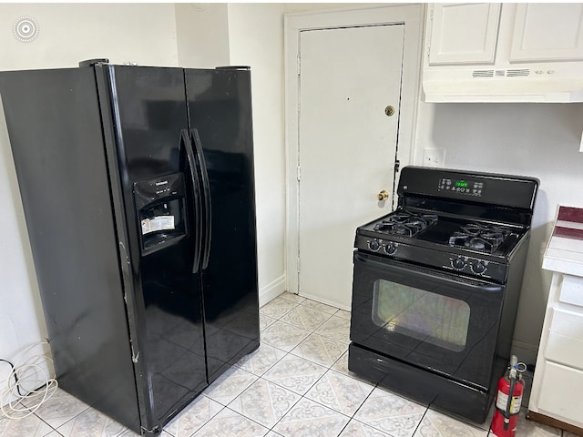 kitchen featuring light tile patterned floors, white cabinetry, extractor fan, and black appliances