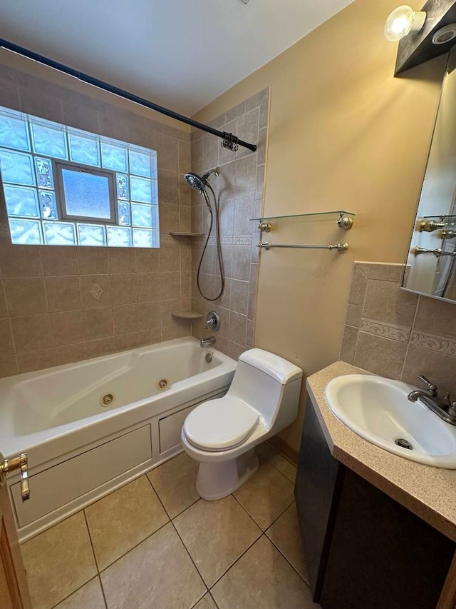 full bathroom with tile patterned floors, vanity, tiled shower / bath combo, and toilet