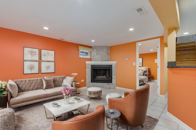 tiled living room featuring a tiled fireplace