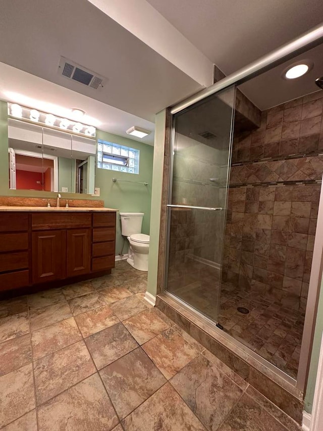 bathroom with vanity, an enclosed shower, and toilet