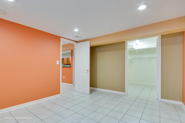 unfurnished bedroom featuring a closet and light tile patterned floors