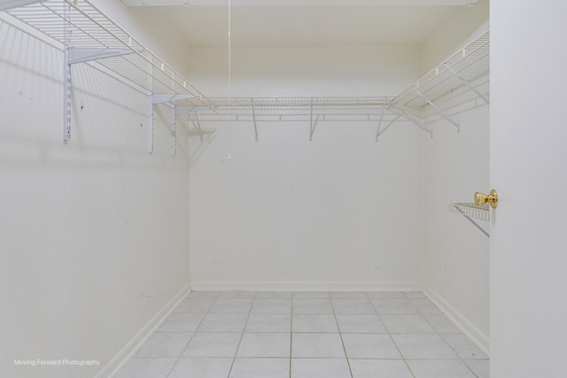 spacious closet with tile patterned floors