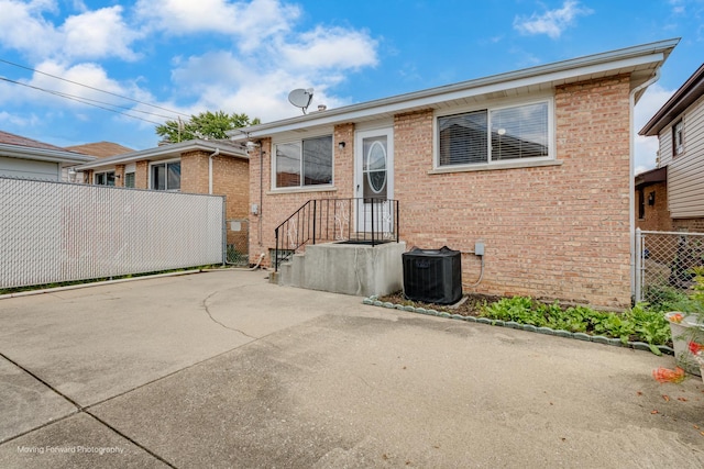 view of front of property featuring central AC and a patio area