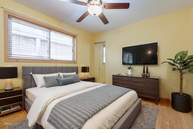 bedroom featuring light wood-type flooring, a closet, and ceiling fan