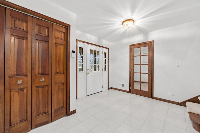 entrance foyer featuring visible vents, french doors, and baseboards