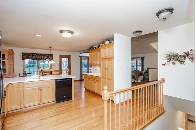 kitchen with sink, pendant lighting, light brown cabinets, dishwasher, and light hardwood / wood-style floors