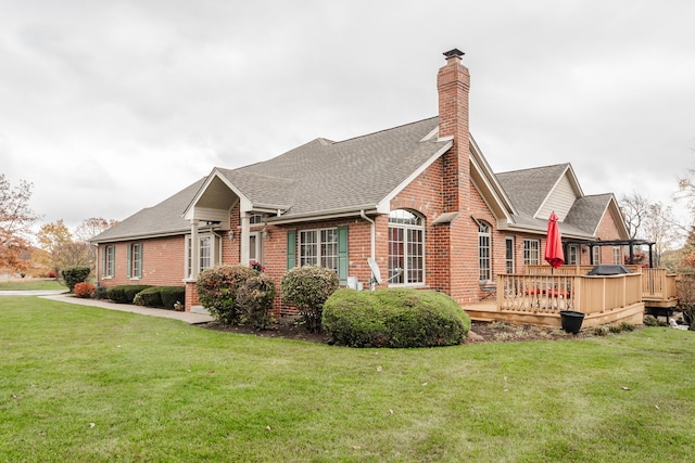 view of home's exterior featuring a deck and a lawn