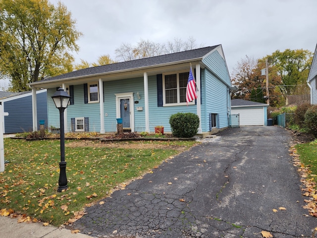 view of front facade with an outbuilding, a garage, and a front yard