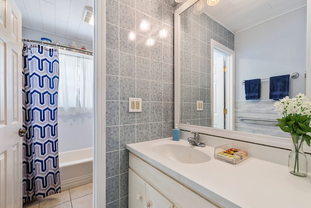 bathroom featuring tile walls, vanity, shower / bath combo with shower curtain, and tile patterned floors