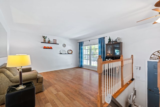 living room with ceiling fan and light wood-type flooring