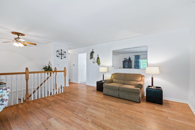 living room with light wood-type flooring and ceiling fan